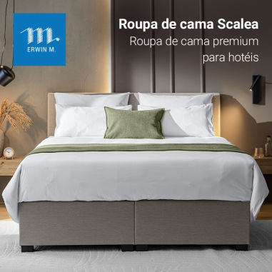 Roupa de cama Scalea exposta numa cama box spring num quarto de hotel